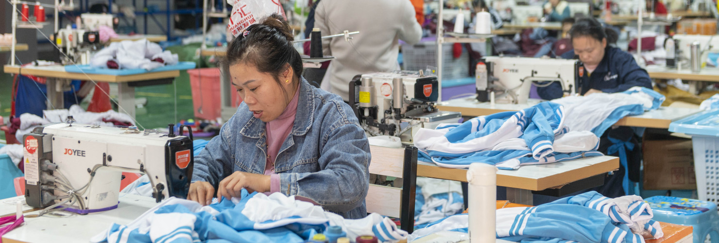 Workers make an order at a workshop of a clothing company