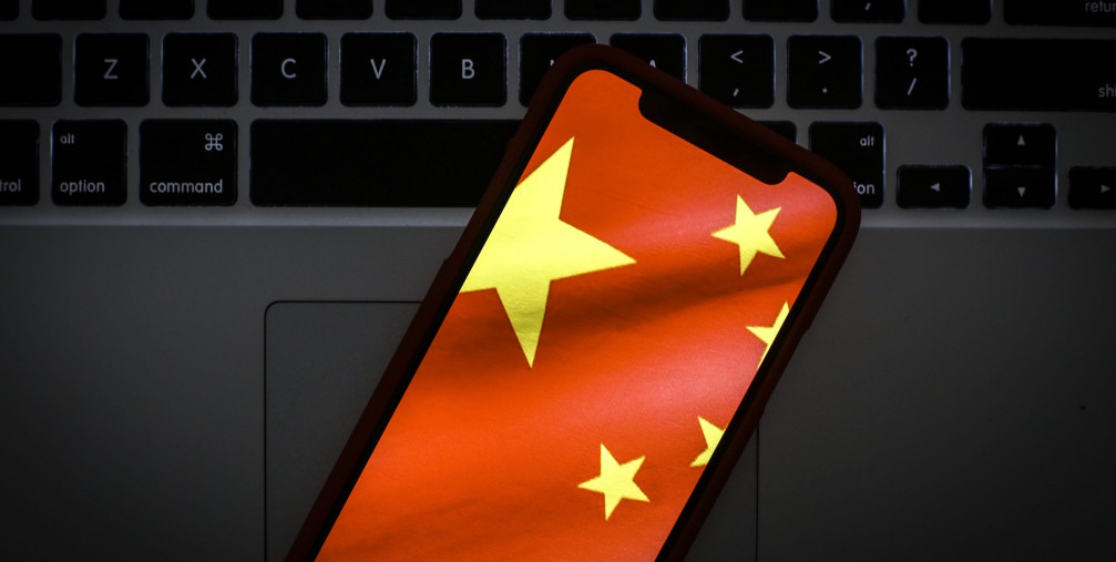 The Chinese flag is seen on a portable mobile device in this photo illustration