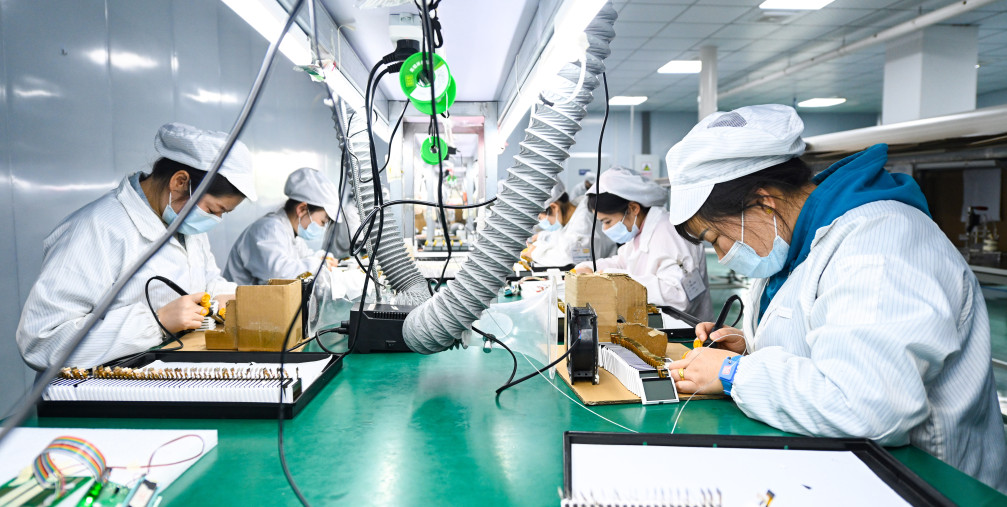 Workers make liquid crystal displays and modules on the production line at a semiconductor production workshop in China