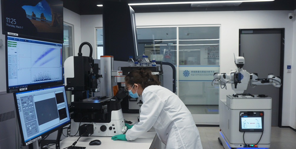 A researcher watches the results of protein analysis on a fully automated single-cell proteome analysis platform at the Hangzhou International Science and Innovation Center Laboratory of Zhejiang University in Hangzhou, Zhejiang province, China, March 7, 2024.