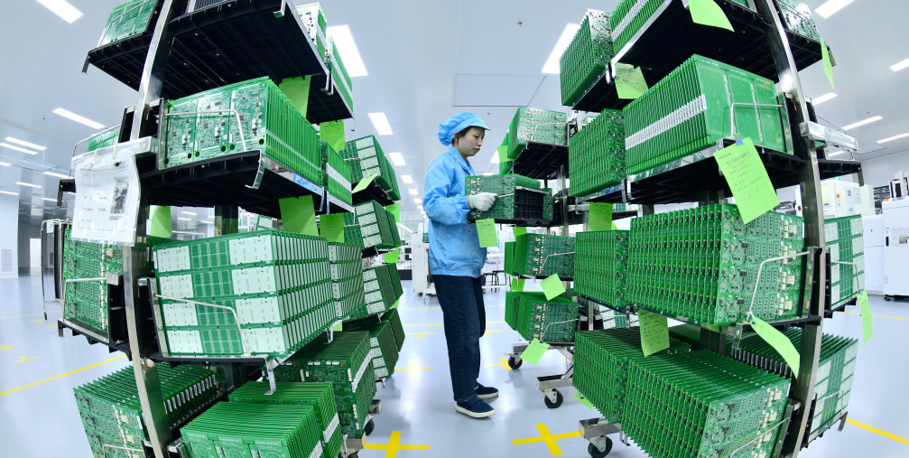 Workers make elevator parts at a fully automated SMT production line in Nantong, Jiangsu Province, China, April 12, 2023.