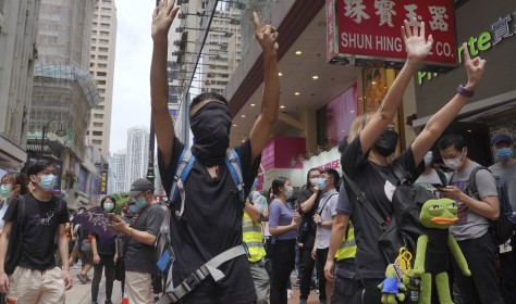 Protesters gesture with five fingers, signifying the "Five demands - not one less" as they march along a downtown street during a pro-democracy protest against Beijing's national security legislation in Hong Kong, Sunday, May 24, 2020. picture alliance / AP Photo