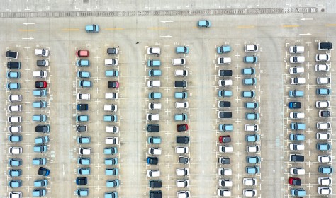 energy vehicles out of a parking lot at a logistics park in Liuzhou