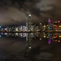 Night view of skyscrapers and high-rise buildings in Central along the Victoria Harbor in Hong Kong