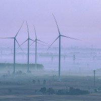 Wind turbines rotate as the sun rises in Zhengji village, Suqian City, Jiangsu Province, China, October 25, 2023.