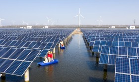 Power workers inspect photovoltaic power generation facilities at a 35-MEGAwatt "fish-light complementary" photovoltaic power station in Binhai, Jiangsu, March 15, 2022