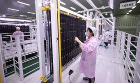 A worker at a photovoltaic company works on a production line in Lianyungang City, Jiangsu Province, China, December 15, 2023.