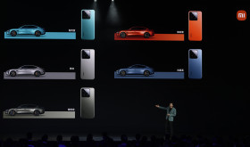 Xiaomi founder Lei Jun shows off the colours of the SU7, a sporty four-door sedan, with matching Xiaomi smartphones in Beijing, Thursday, March 28, 2024. 