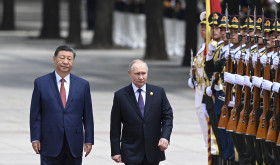 Chinese President Xi Jinping, left, and Russian President Vladimir Putin review the honor guard during an official welcome ceremony in Beijing, China, Thursday, May 16, 2024.